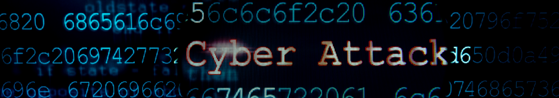 A computer screen with computer code. The word cyber attack in red in amongst the code