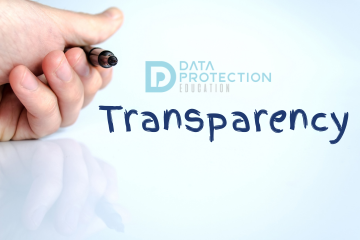 Transparency written in pen, with the Data protection education logo above, a hand holding a pen on the left and a reflection of the hand below it