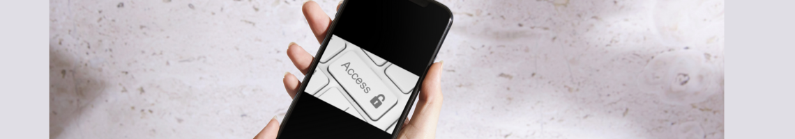 Image of a hand holding a phone with a white keyboard and the word 'Access'