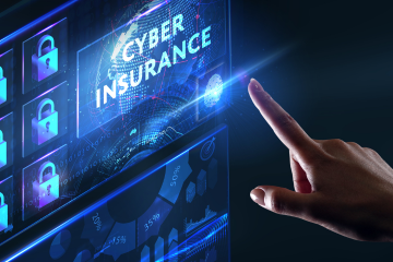 The word cyber insurance in blue on a computer screen with a finger pointing at it