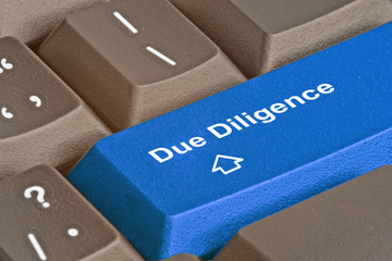 computer keyboard with due diligence on a blue key
